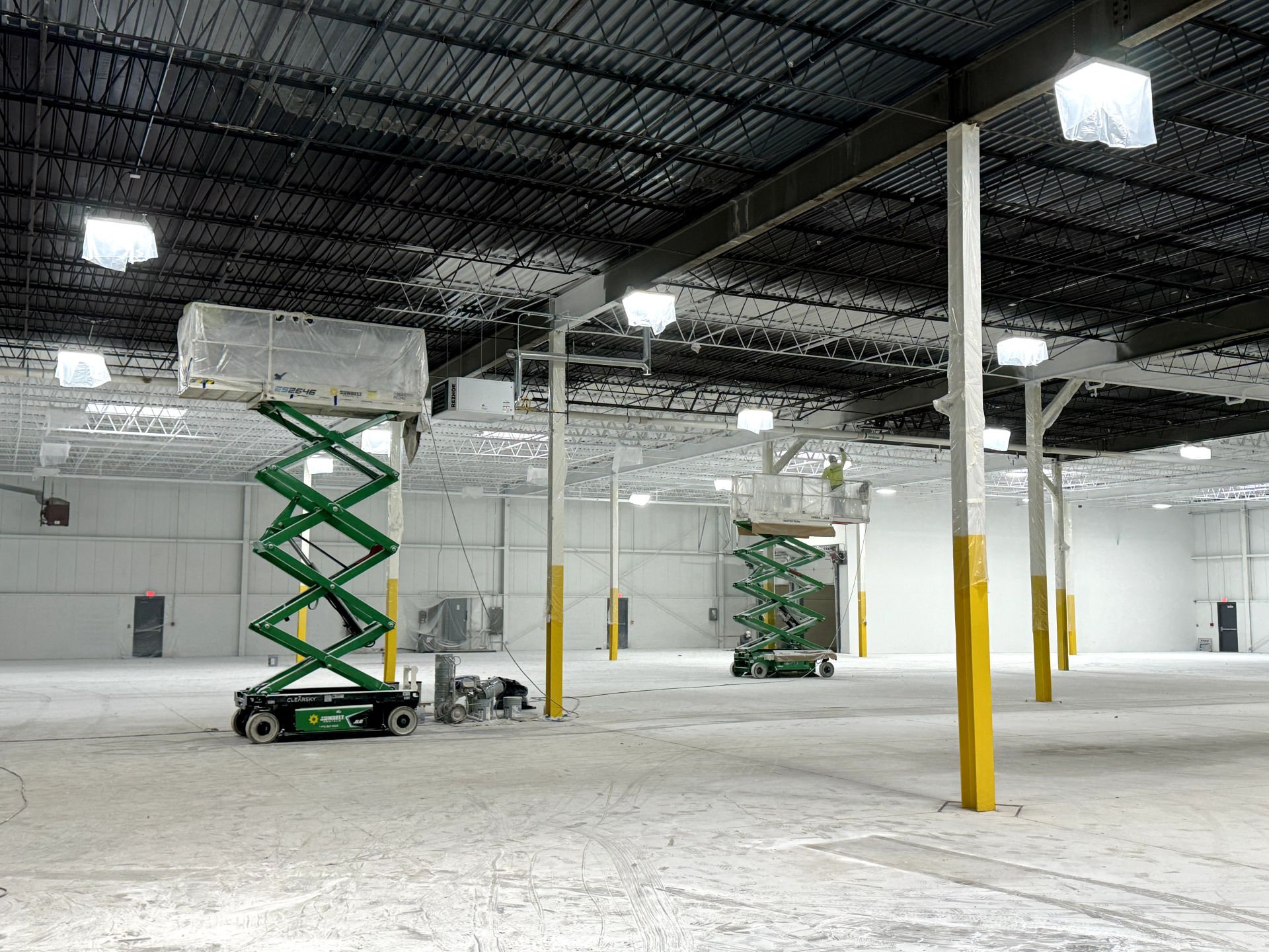 Industrial spray painting of warehouse ceiling and steelwork
